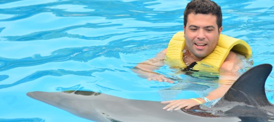 Interacting with dolphins in Dolphinaris' Dolphin Swim Speed Ride