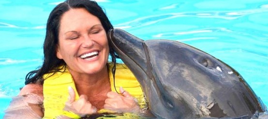 Gina Cox swimming with dolphins. swimming with dolphins